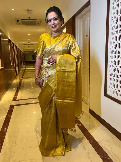 A full-length portrait of the groom's mom. She exudes grace and poise, and her makeup is designed to enhance her timeless beauty.