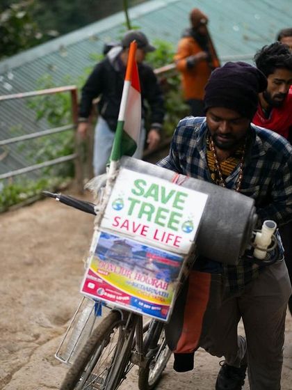 Even on a remote mountain path, we find reminders of our responsibility to the earth. This pilgrim carries a message to "Save Trees, Save Life," a powerful act of devotion to both nature and humanity. It shows that spiritual practice extends to caring for our world.