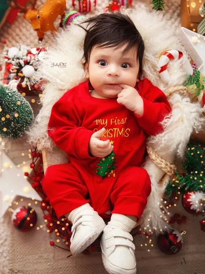 A thoughtful moment amidst the Christmas cheer. The warm lights and festive decorations create a cozy and magical atmosphere.