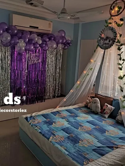Another look at the canopy setup with a purple and silver theme. The dreamcatcher and vine details on the canopy add a whimsical touch to the romantic bedroom decor.