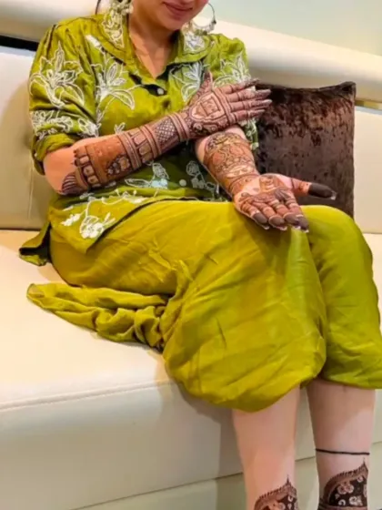 A relaxed moment with a client showcasing her elegant mehandi design.
