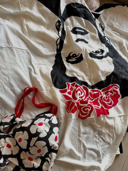 A flat-lay of the outfit, showing the beautiful hand-painted face on the pallu of the saree and the coordinated floral blouse. This is how I plan a look, making sure every element tells a story.