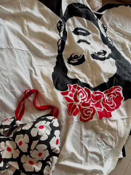 A flat lay of my saree date outfit. You can see the beautiful hand-painted face on the pallu and the floral print on the halter-neck blouse. It's all about curating pieces that tell a story together.