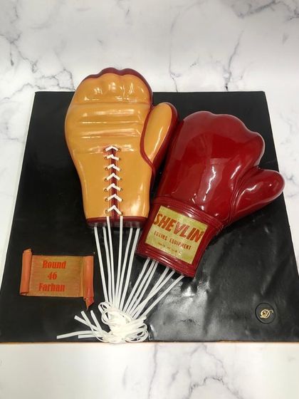 A pair of sculpted boxing gloves for Farhan Akhtar's birthday, a nod to his role in the film 'Toofaan'. I love bringing such creative and personal themes to life.