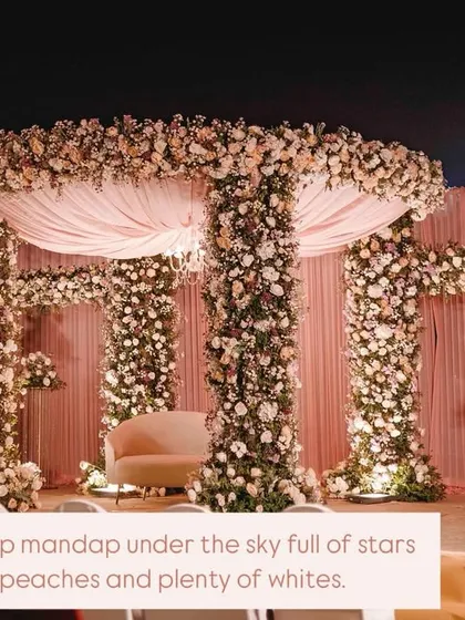 For Sakshi and Shuvam's wedding, we created this opulent mandap under the stars. The structure was completely covered in lush pink, peach, and white florals, with a soft fabric canopy and a chandelier for a touch of timeless elegance.