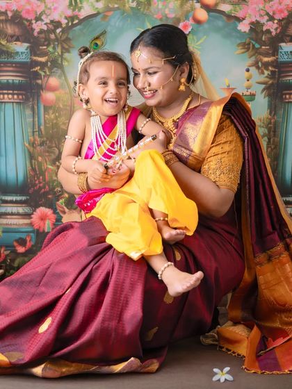 The infectious laughter of a child makes every photo special. This candid shot captures the pure happiness of the moment during a Yashoda Krishna session.