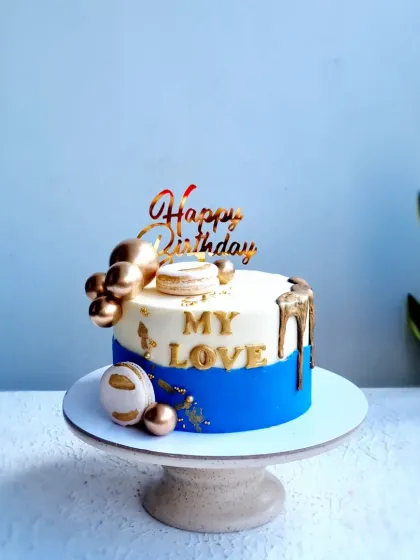 A full view of the blue and gold "My Love" birthday cake.
