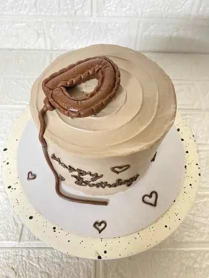 A top-down perspective of our minimalist balloon cake, showing the clean swirl on top.