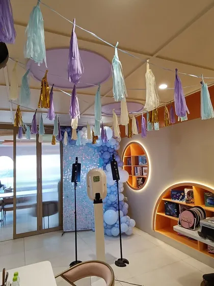 Another angle of the party space, showing the ceiling decorated with pastel tassels. This demonstrates our attention to detail, ensuring that every part of the venue, from floor to ceiling, contributes to the overall theme.
