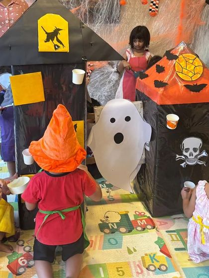 Exploring the haunted house we built for our Halloween party. This interactive setup allowed the kids to engage in imaginative play.