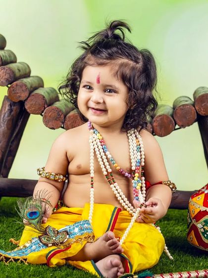 This little Kanha is ready for the festivities, holding his peacock feather and looking absolutely adorable.