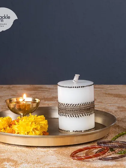 A simple yet elegant mehendi pattern on a white pillar candle. I love how these designs look when the candle is lit from within.