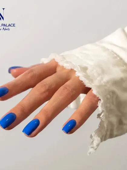 This photo highlights the flawless finish of a vibrant blue gel manicure. The color is rich and even, and the high-gloss top coat ensures a long-lasting, brilliant shine.
