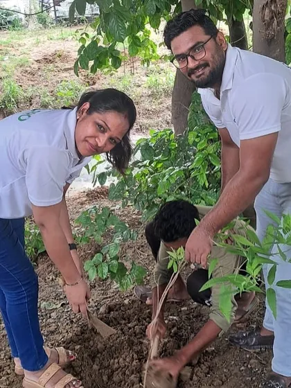 A team from Calpro Specialities works with our on-ground staff to plant a tree, showcasing the collaborative spirit of our community drives.