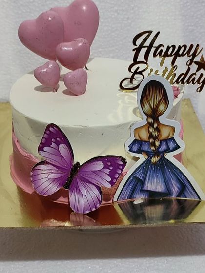 A sweet and simple birthday cake with a girl and butterfly topper.