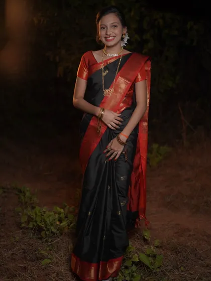 A full-length portrait showcasing the complete traditional look for Makar Sankrant. The subject's confident pose and the beautiful fall of the saree are captured in this well-lit night shot.
