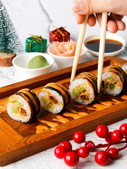 Tiger-striped sushi rolls styled with Christmas props for a festive menu.
