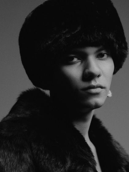 A tight, shadowy portrait that creates an intense and intimate mood. The focus is on the model's gaze and the texture of the fur, demonstrating my skill in directing for emotional impact.