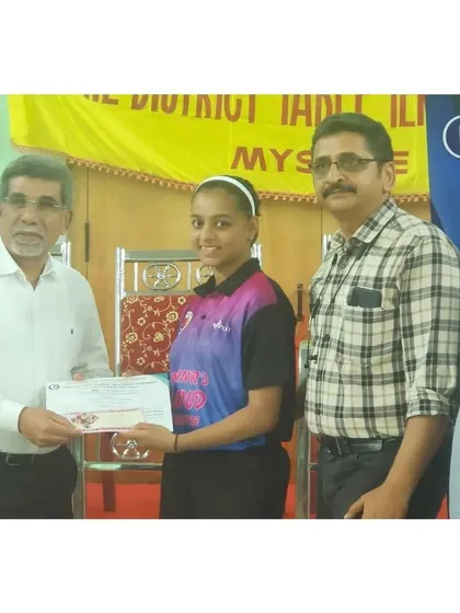 Sahana H Murthy receiving her award for winning the U17 Girls Champion title at the Mysore State Ranking Tournament.