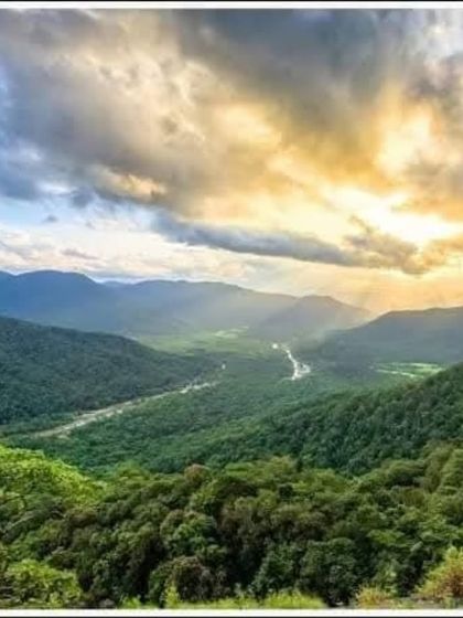 A breathtaking sunset view from Jenukallu Gudda, painting the sky with dramatic colors over the Western Ghats.