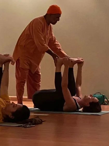 Assisting a student in Ananda Balasana (happy baby pose) helps to release the lower back and hips. Personal attention is a key part of my teaching, ensuring each student practices safely and effectively.