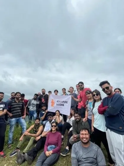 The whole crew on a hilltop in Chikmagalur, holding up the Adventure Buddha banner. This is what our tribe looks like.
