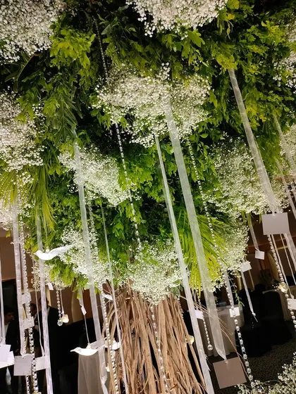 A view looking up into the canopy of the Wish Tree. The combination of lush foliage, clouds of baby's breath, and sparkling crystals created a truly immersive and magical experience.