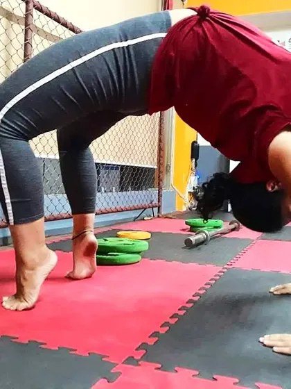 A close-up of the wheel pose, showing the deep arch in the back and the engagement of the arms and legs. This is a powerful posture for building a strong back.
