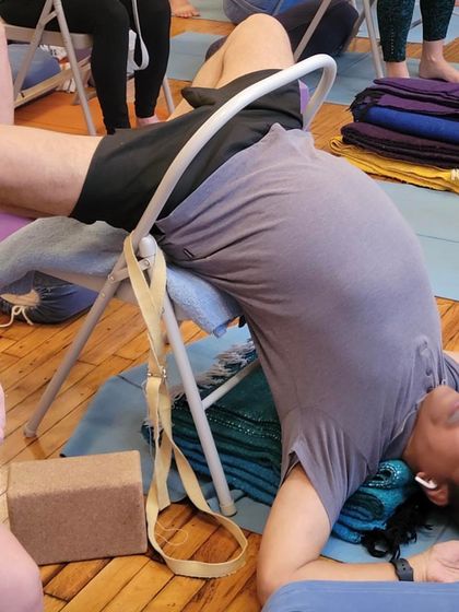 A supported backbend on a chair.