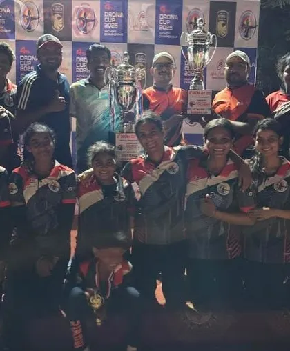 The winning team from Drushti Archery Academy celebrating their first prize victory at the 4th Drona Cup 2025, holding their championship trophies high.