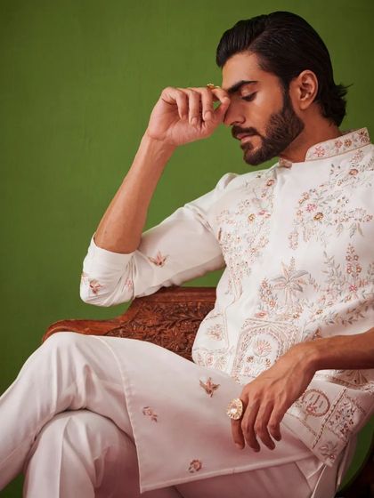 A pensive moment captured in a white embroidered kurta set. The delicate embroidery and the soft fabric create a look of serene elegance.
