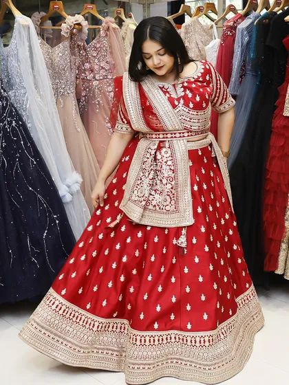 This is how you own your moment. A full view of a stunning red bridal lehenga, showcasing its flow and intricate design, perfect for making a grand entrance.
