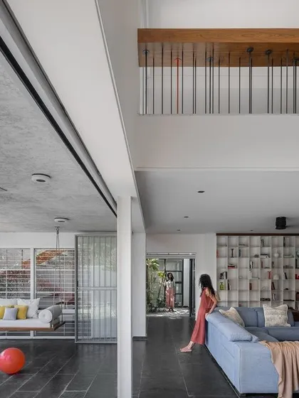We believe a home should embrace the entire family, including pets. In our 'Maya House' project, the living room's sliding glass walls completely open up to the garden and patio swing, creating a seamless indoor-outdoor living area for everyone to enjoy together.