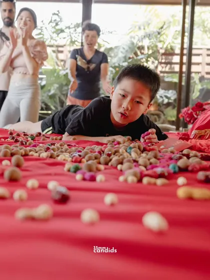 A young boy rolls on the wedding bed, a playful part of the Chinese ritual to bless the couple with fertility and a happy family life.