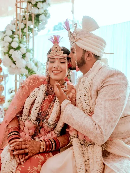 A sweet moment between the newlyweds. Her soft, glowing makeup looks perfect next to his happy smile.