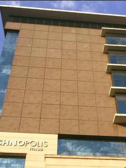 A detailed look at the facade of the Technopolis IT Hub. The grid-like pattern of the cladding provides a sense of order and scale to the structure.