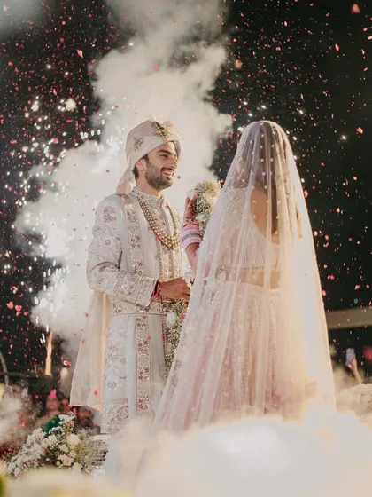 The magical Varmala moment, surrounded by smoke effects and fireworks. I specialize in creating these jaw-dropping moments that become the highlight of the wedding ceremony.