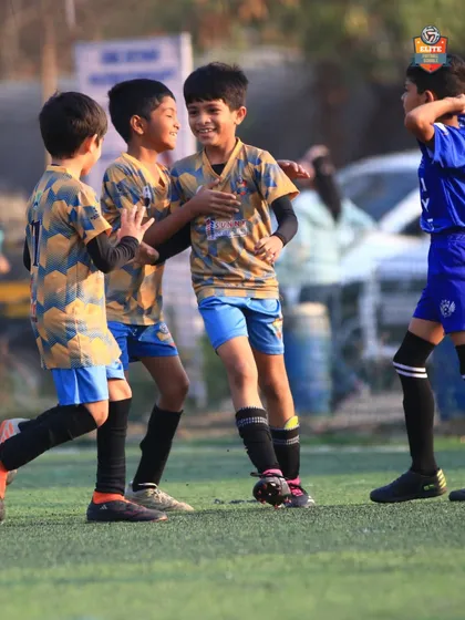 Teamwork makes the dream work. Players celebrating a key moment in their Leno Premier League match.