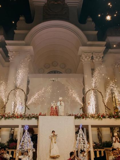 A grand wedding moment for Tushar and Samta with fireworks lighting up the palatial venue. This captures the celebratory spirit of a lavish destination wedding.
