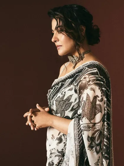 The profile view highlights the intricate patterns of this Torani saree and the soft, elegant hairstyle chosen for this look.
