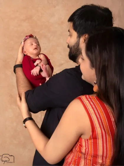 A beautiful first family portrait. The parents gaze at their newborn with so much love and wonder. A truly priceless moment.
