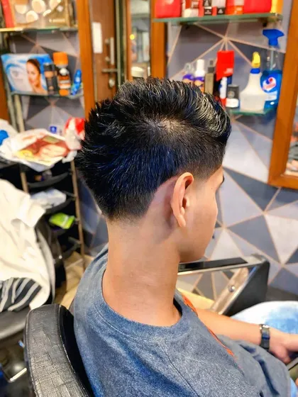 Another angle of the textured haircut with a taper fade, showing how the style looks from the back and side.