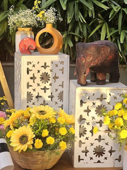 Even small details can make a big impact. These decorative boxes with elephant props and flower vases were used to enhance the corners of a traditional event space.