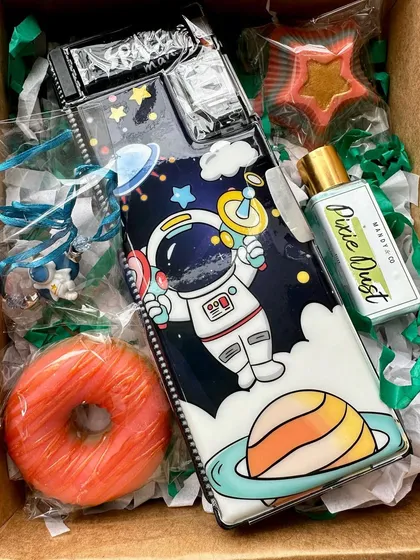 An out-of-this-world space-themed gift box for kids, including soaps, a pencil box, and a fun astronaut rakhi.