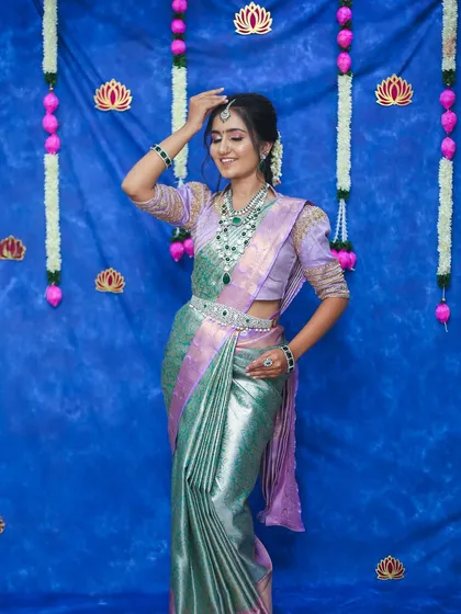 A full-length view of the bride in her tissue saree, showing how the long Victorian haram creates a graceful and elongated silhouette.