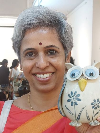 This lovely customer is holding one of my signature owl vases. Each one is hand-built and painted, so no two are ever exactly alike.