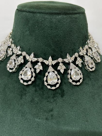 A delicate American diamond choker with teardrop pendants. This is a beautiful rental option for an elegant evening look.