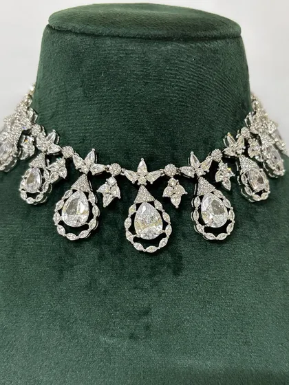 A delicate American diamond choker with teardrop pendants. This is a beautiful rental option for an elegant evening look.
