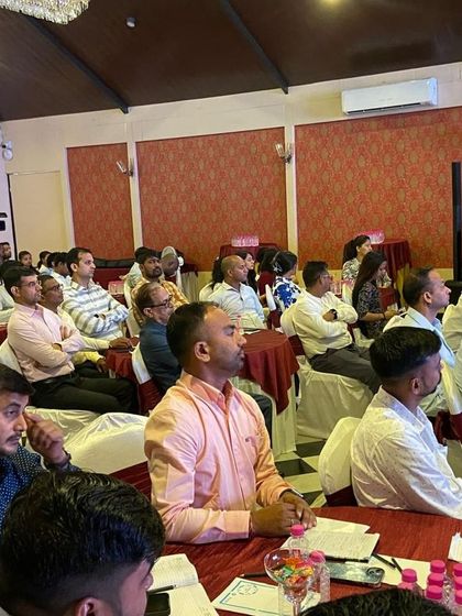 Our team members listening intently during a session at the 'Ullas 2.0' sales meet. These events are filled with insightful presentations and inspiring stories of growth.
