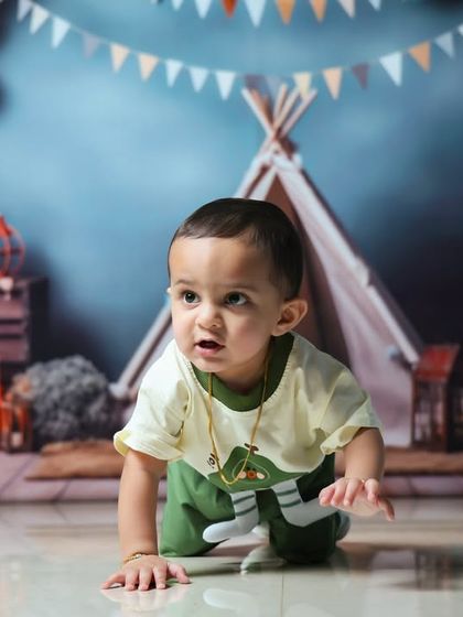 He's ONE. This classic first birthday setup with a teepee, balloons, and letter blocks is a popular choice for celebrating this special day.